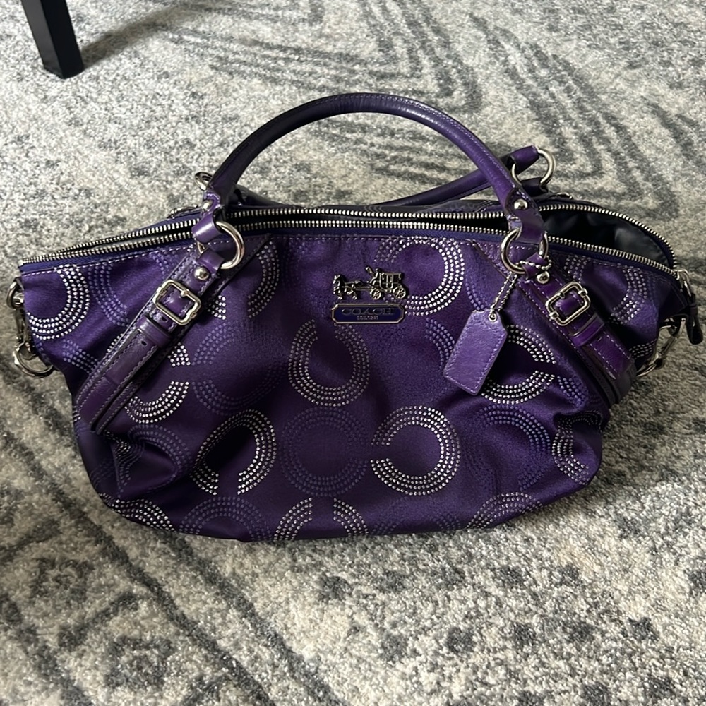 Purple Coach handbag with attachable over the shoulder strap.